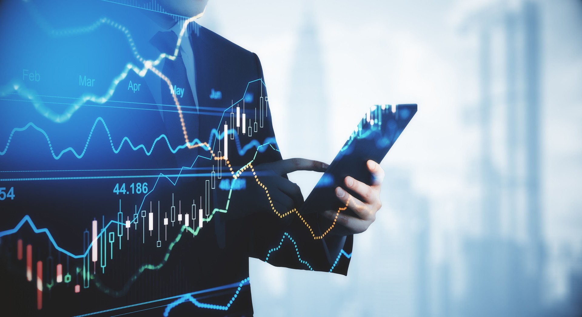 Trading and investment concept trader silhouette with digital tablet and virtual screen with financial chart graphs and candlestick.